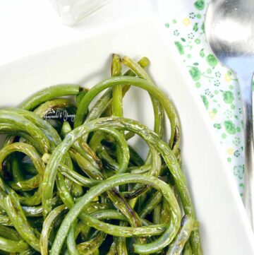 Grilled Garlic Scapes in a white bowl ready to eat.