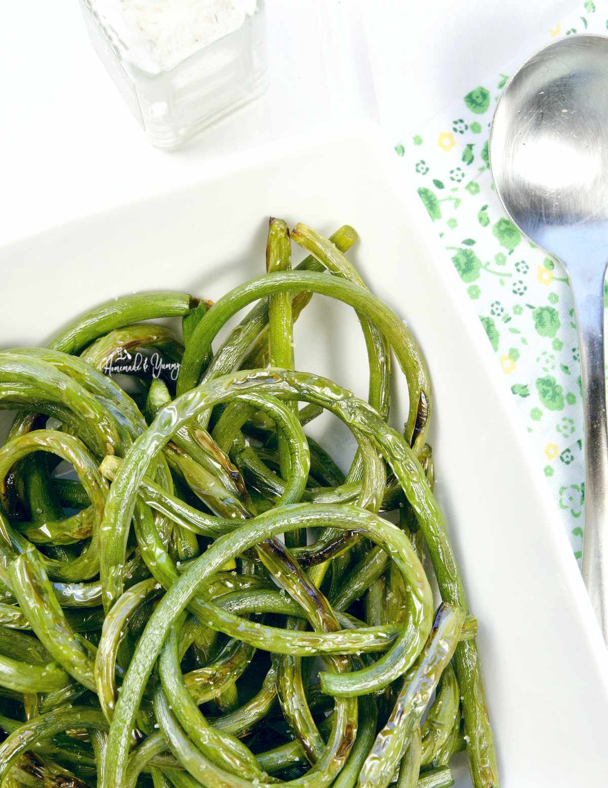 Grilled Garlic Scapes in a white bowl ready to eat.