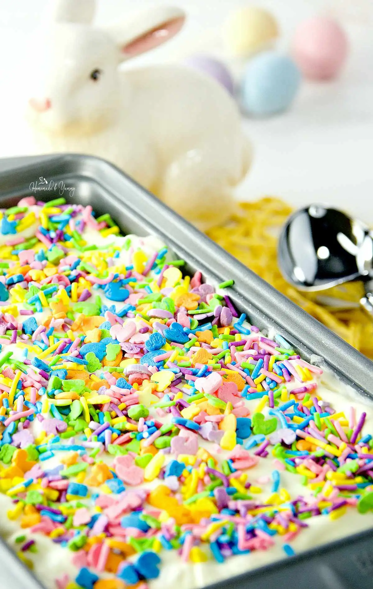 A container of lemon ice cream topped with Easter sprinkles.