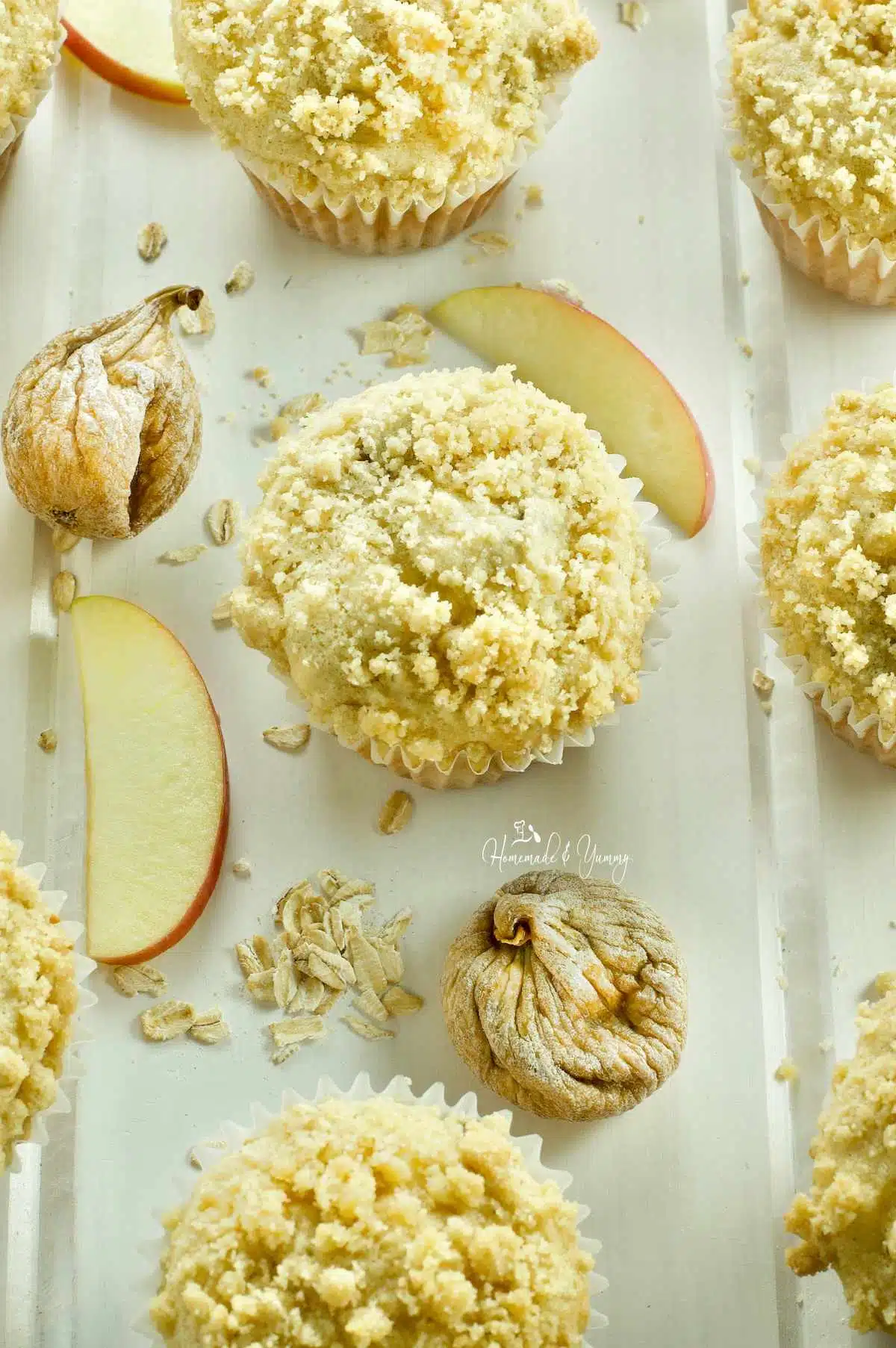 Fresh baked apple oatmeal muffins with figs and crumb topping.