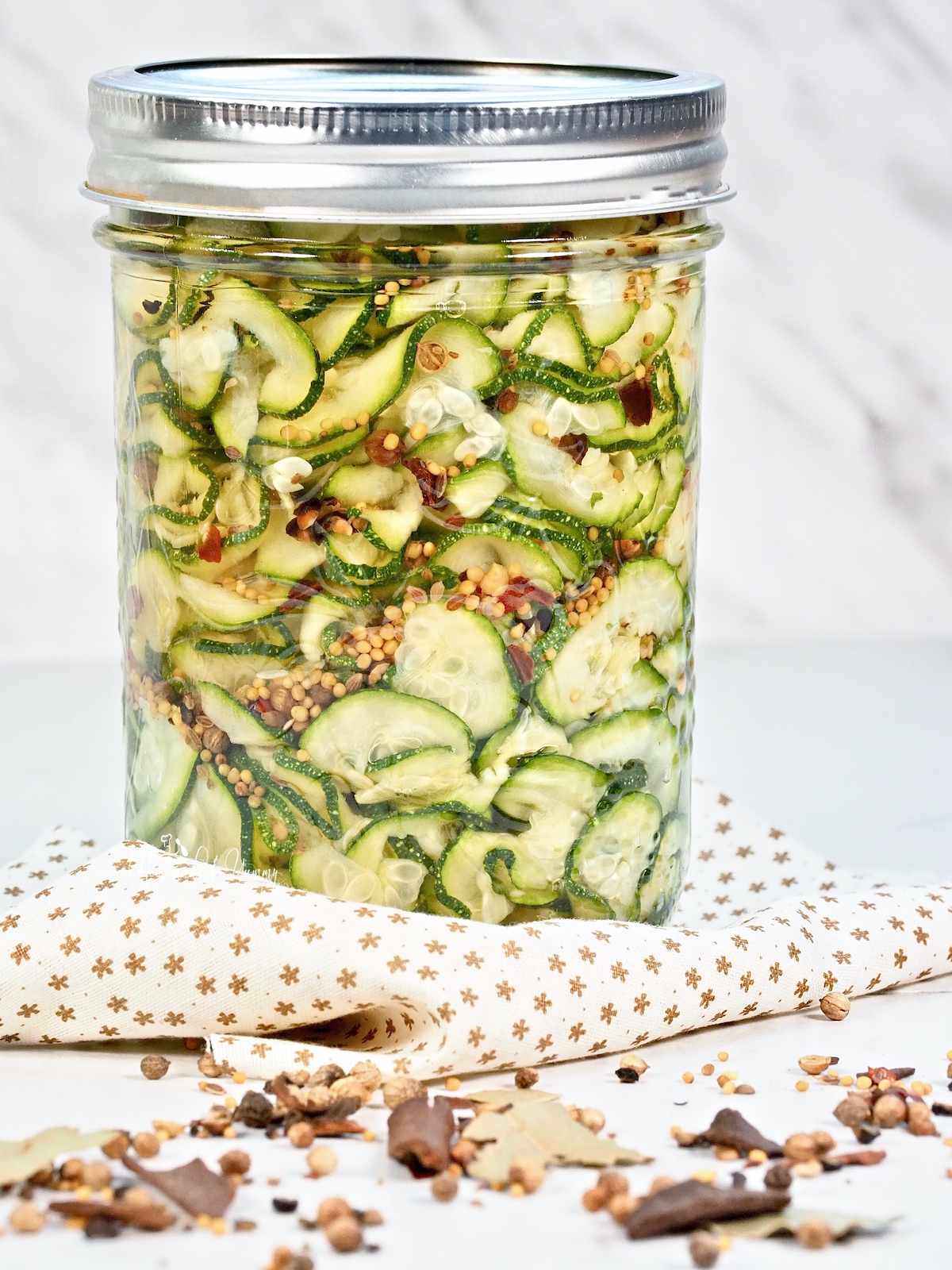 A jar of pickled zucchini ribbons ready to eat.