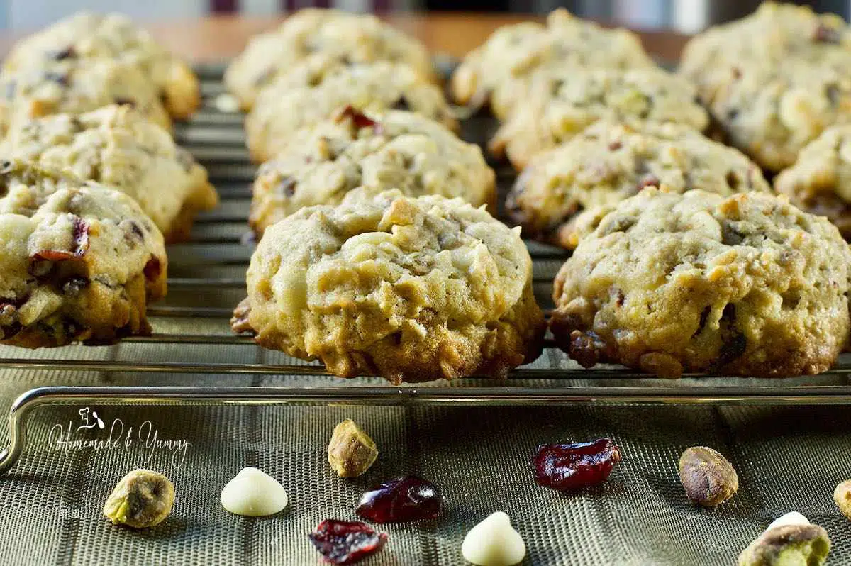 Oatmeal cookies with cranberries and white chocolate cooling on a rack.