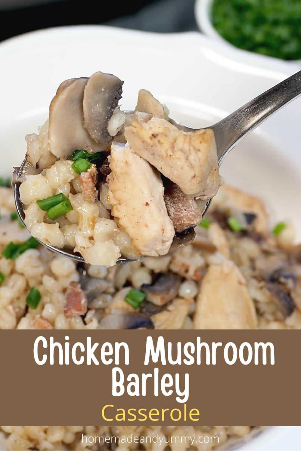 A spoonful of baked casserole with chicken, barley and mushrooms.