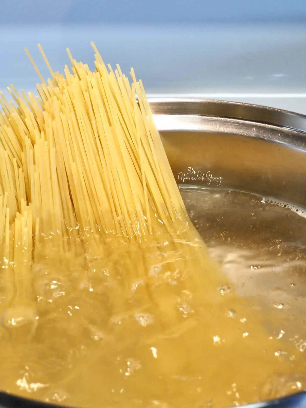 Spaghetti noodles boiling in a pot.