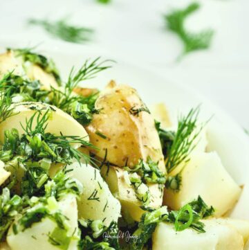 Potatoes with Green Onion and Dill in a bowl.