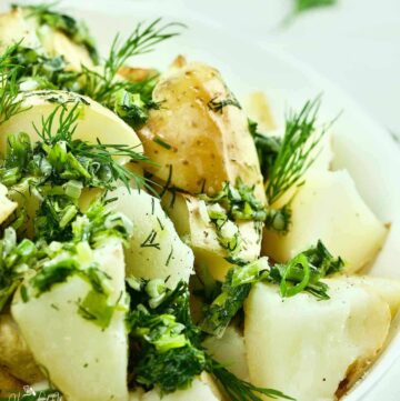 Ukrainian green onion and dill potatoes in a serving bowl.