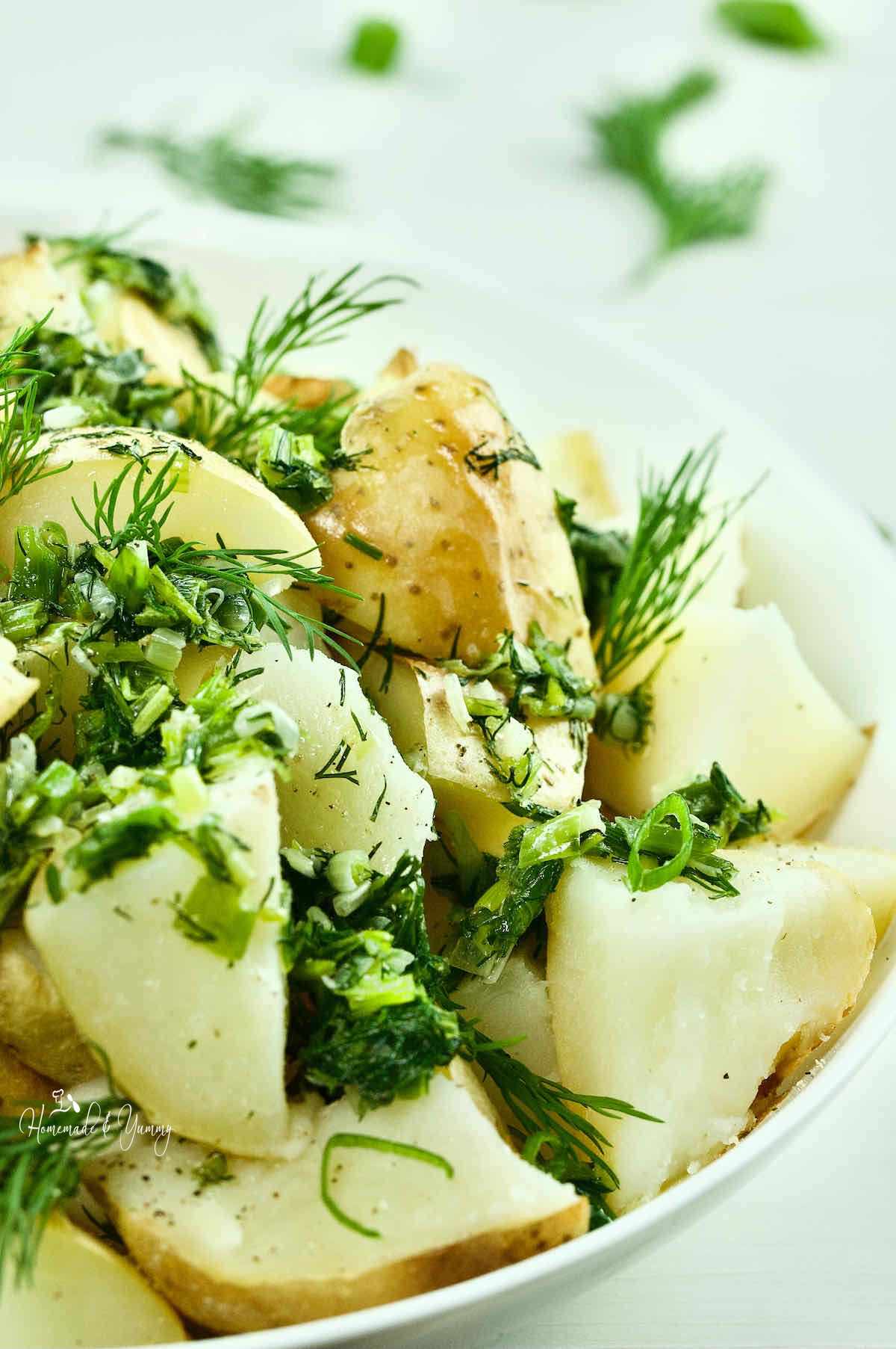 Ukrainian green onion and dill potatoes in a serving bowl.