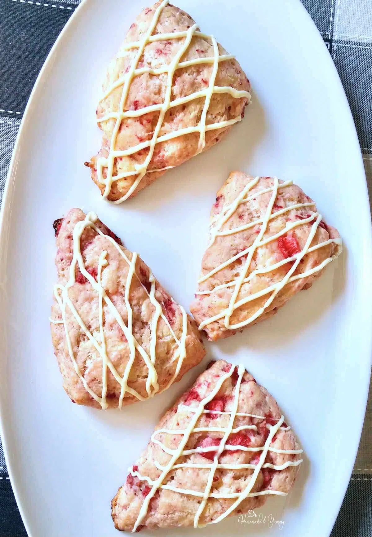 Strawberry scones drizzled with white chocolate.