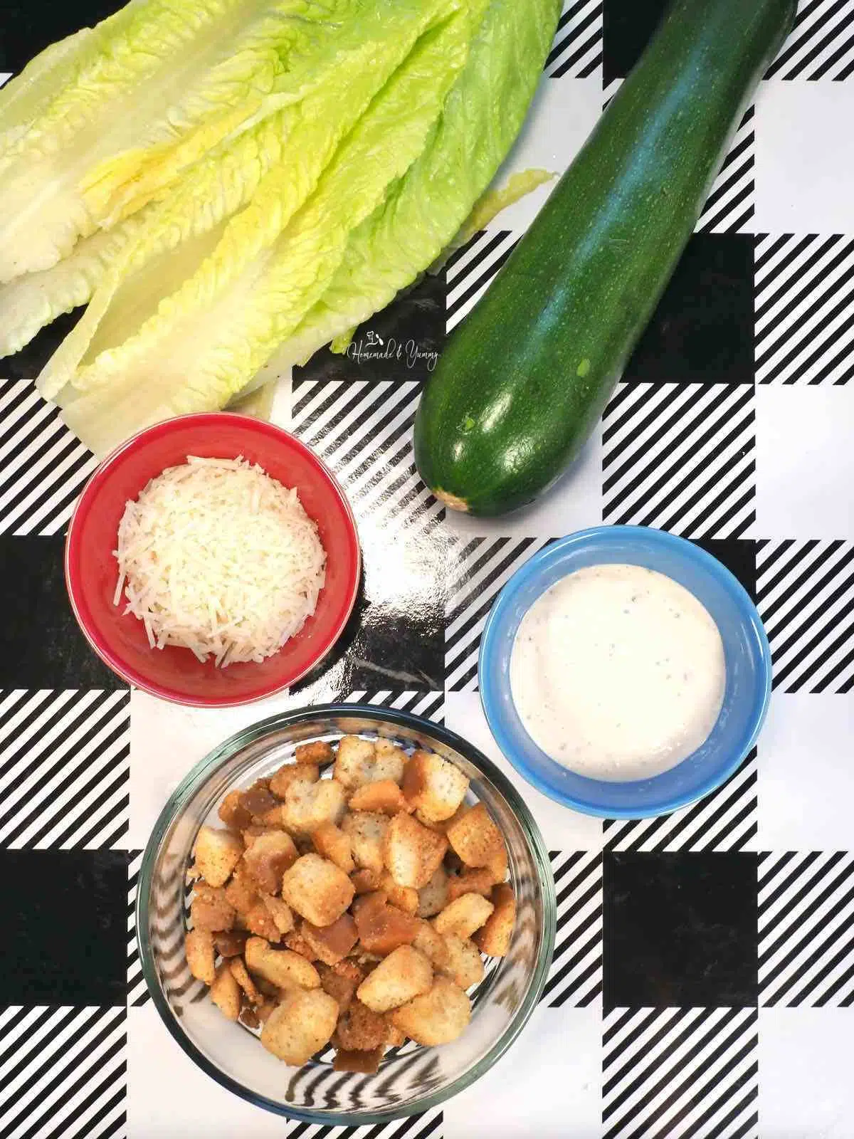 Ingredients to make Caesar salad with zucchini.