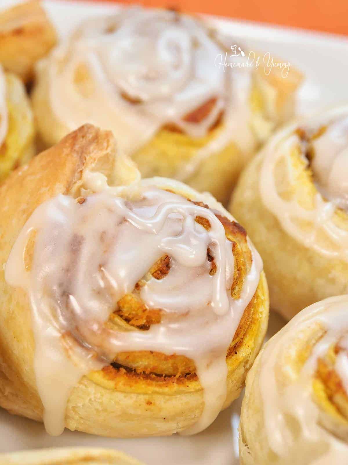 A cinnamon roll made with pumpkin and glazed with maple icing.