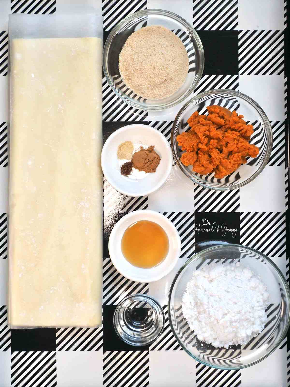 Ingredients to make pumpkin rolls with puff pastry.