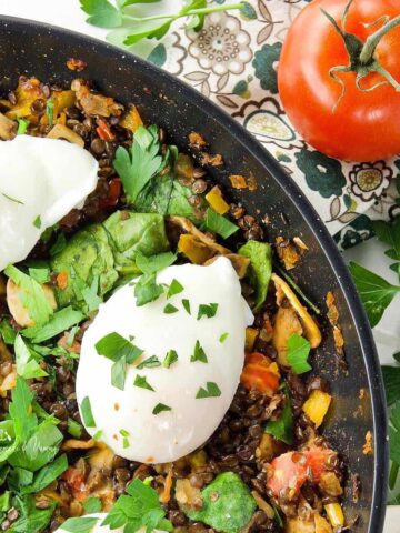 Poached Eggs and Lentil Hash in a pan.