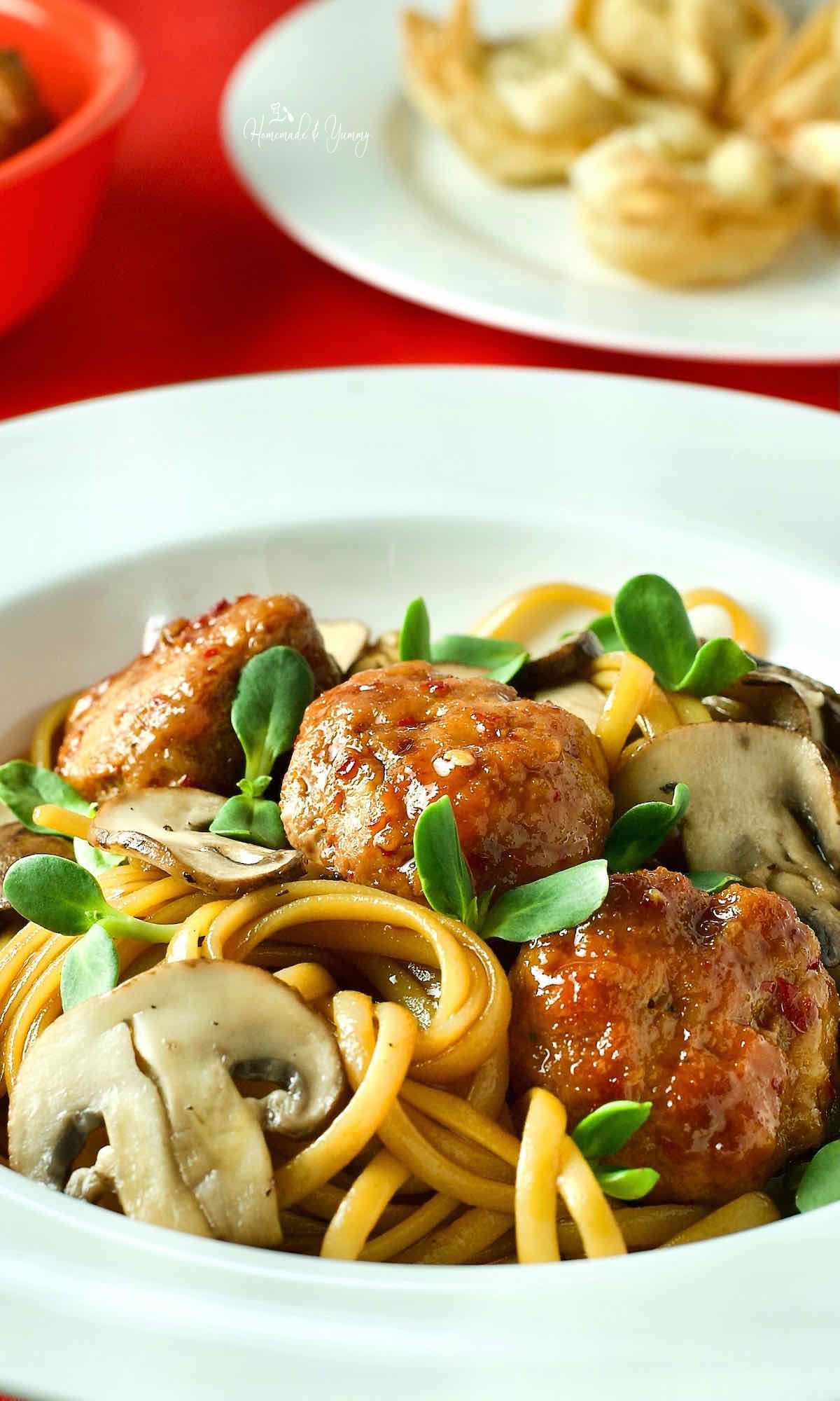 Chinese pork meatballs with spaghetti noodles.