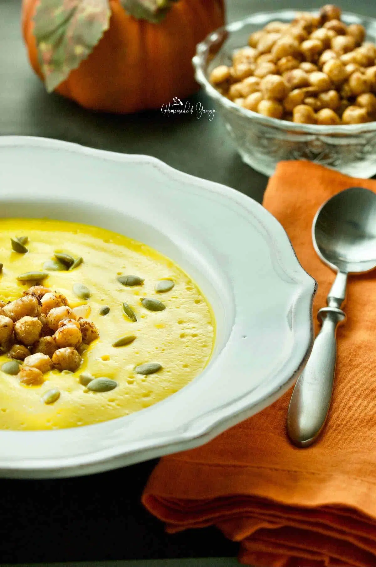 Easy Roasted Pumpkin Soup in a white bowl with chickpeas.