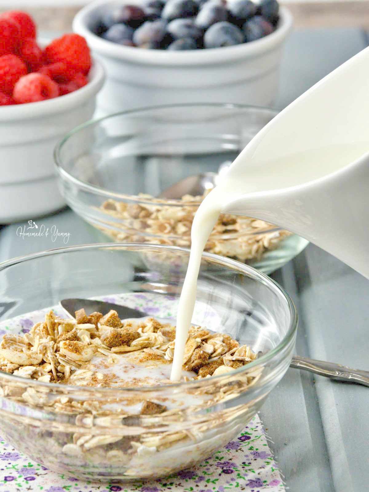 Pouring milk on muesli cereal.