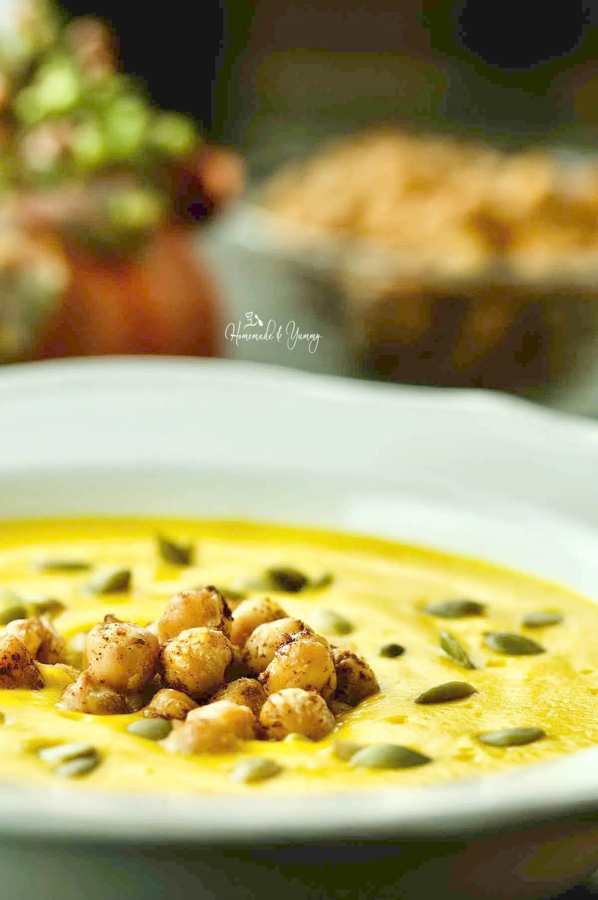 Chickpeas and pumpkin seeds are garnish on the soup.
