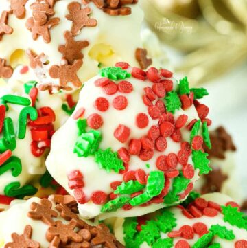 White Chocolate Popcorn Balls covered with Christmas sprinkles.