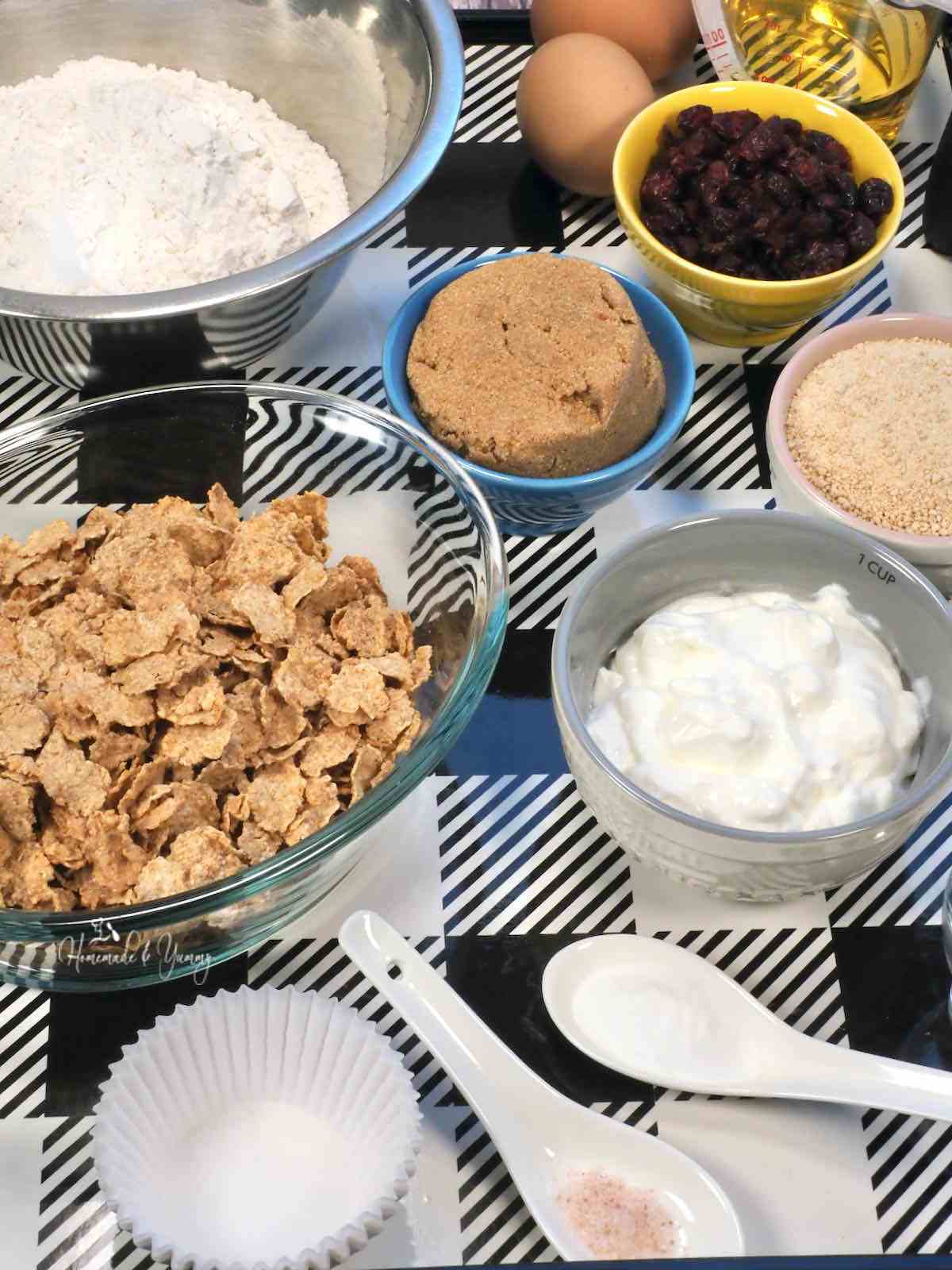 Ingredients to make muffins with bran flakes and cranberries.