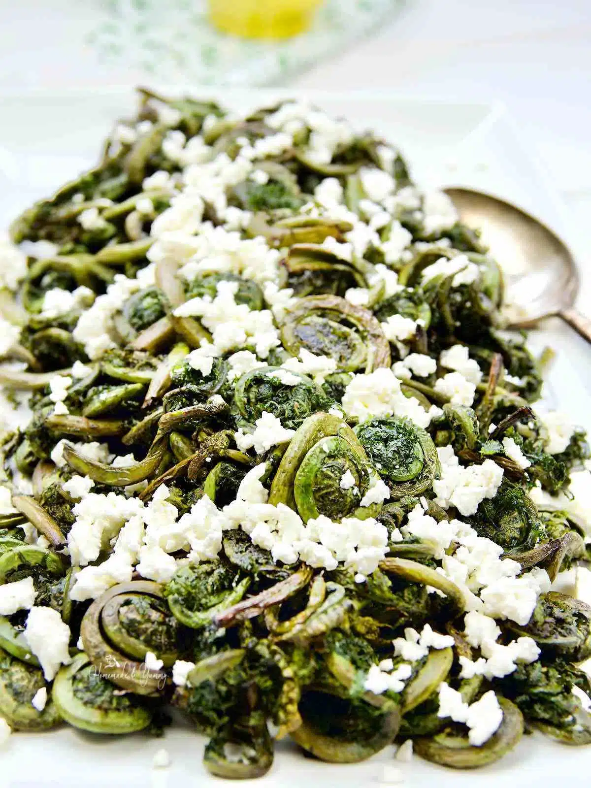 Fiddleheads roasted and topped with feta cheese.