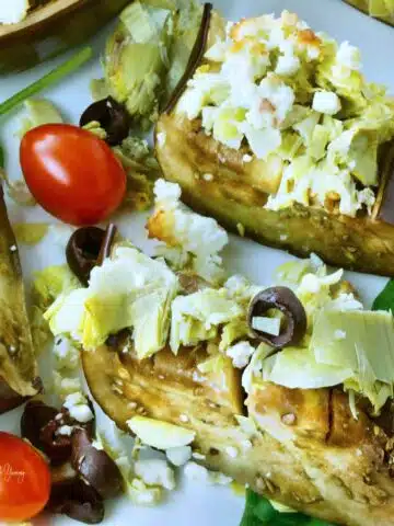 Roasted Eggplant Slices with artichokes, feta and olives.