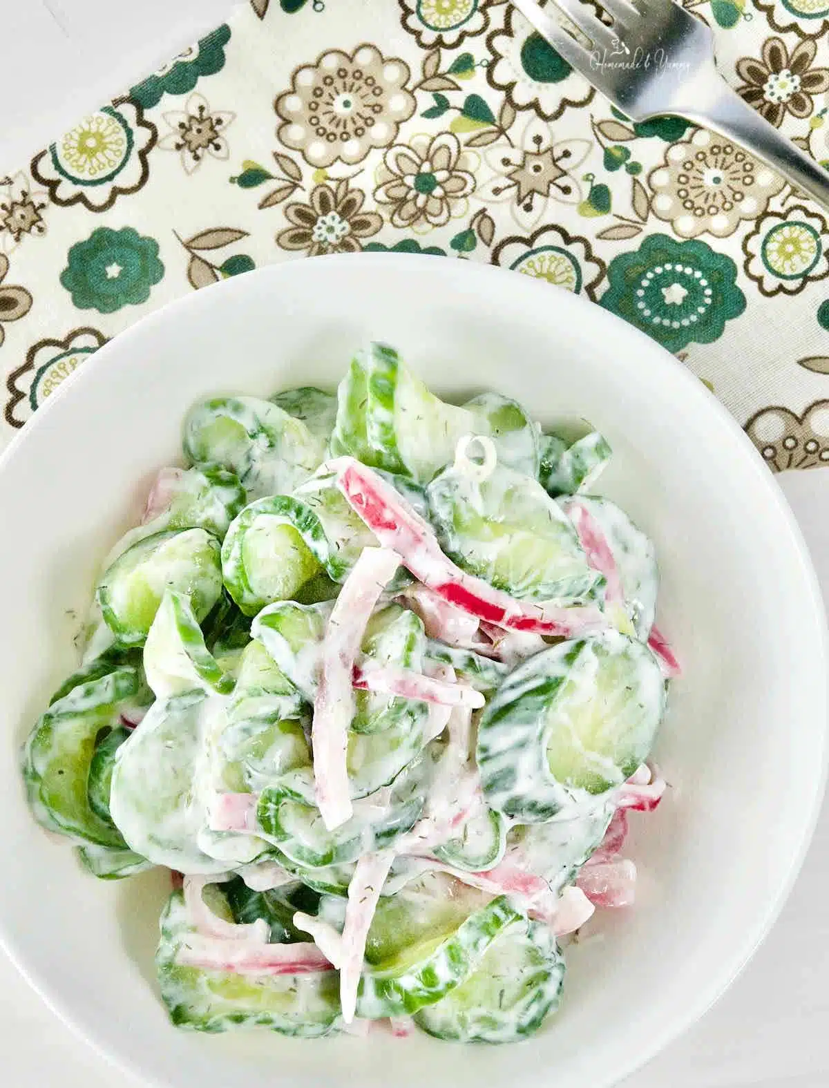 Old fashioned simple salad with cucumbers, pickled onions and sour cream.