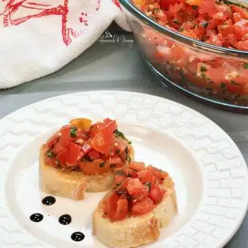 2 pieces of bread topped with tomato bruschetta.