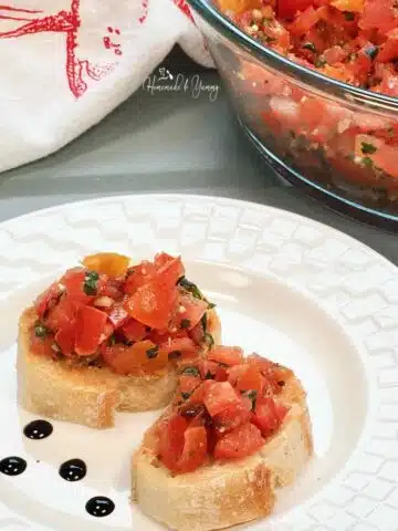 2 pieces of bread topped with tomato bruschetta.