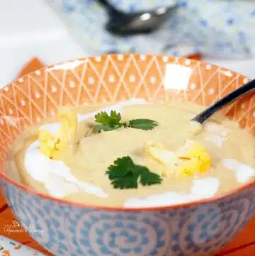 Curried orange cauliflower soup in a bowl.