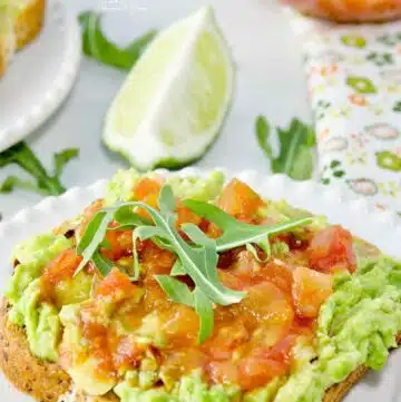 Smashed avocado on toast topped with spicy salsa.