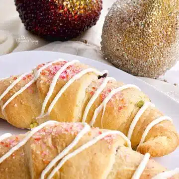 Festive holiday croissants with sprinkles and glaze.