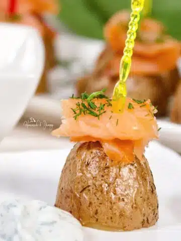 Gourmet smoked salmon and potato appetizers with sour cream dip.