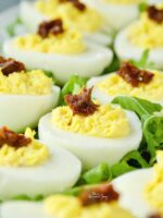Devilled eggs flavoured with bacon and sun-dried tomatoes.