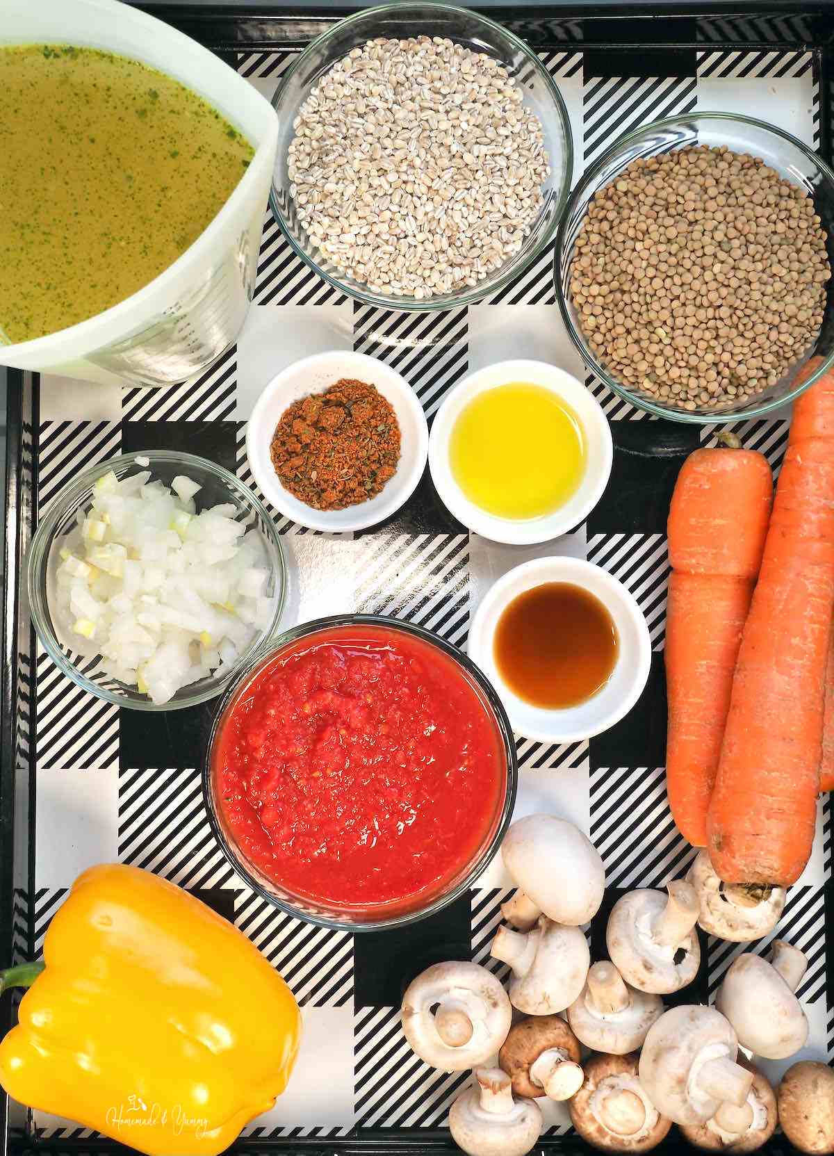Ingredients for making vegan lentil and barley soup with vegetables.
