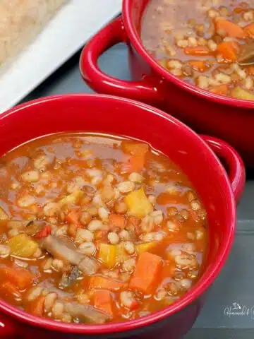 A bowl of vegetarian barley lentil soup ready to eat.