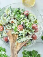 Greek zoodle salad with tomatoes and black olives.
