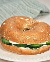Cucumber bagel sandwich with cream cheese and dill.