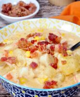 Slow cooker fish chowder soup topped with bacon.
