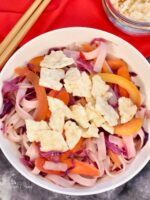 Noodles and cabbage stir fry in a bowl.