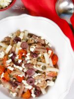 Canned tuna pasta with tomatoes, olives and capers.