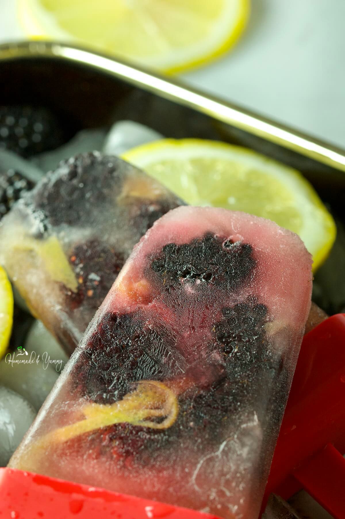 Ice pops with lemon tea and fresh blackberries.