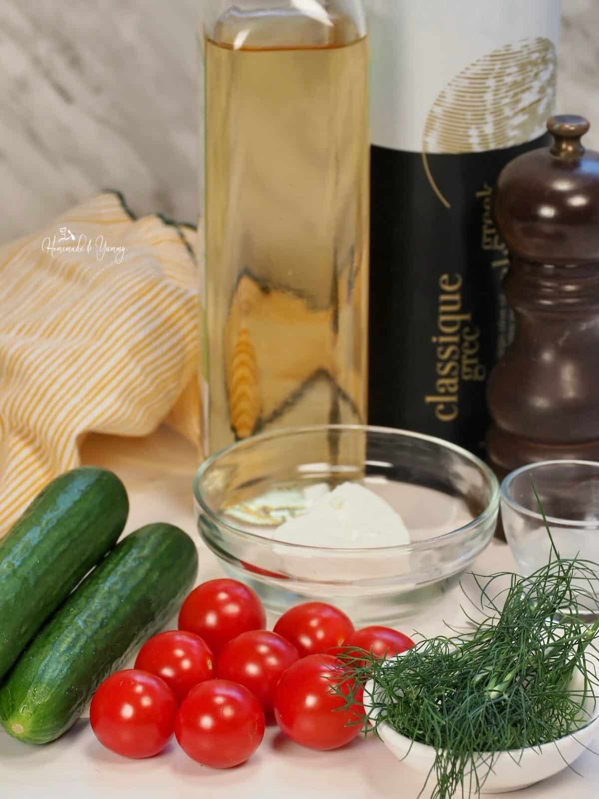 Ingredients to make a cucumber and tomato salad.