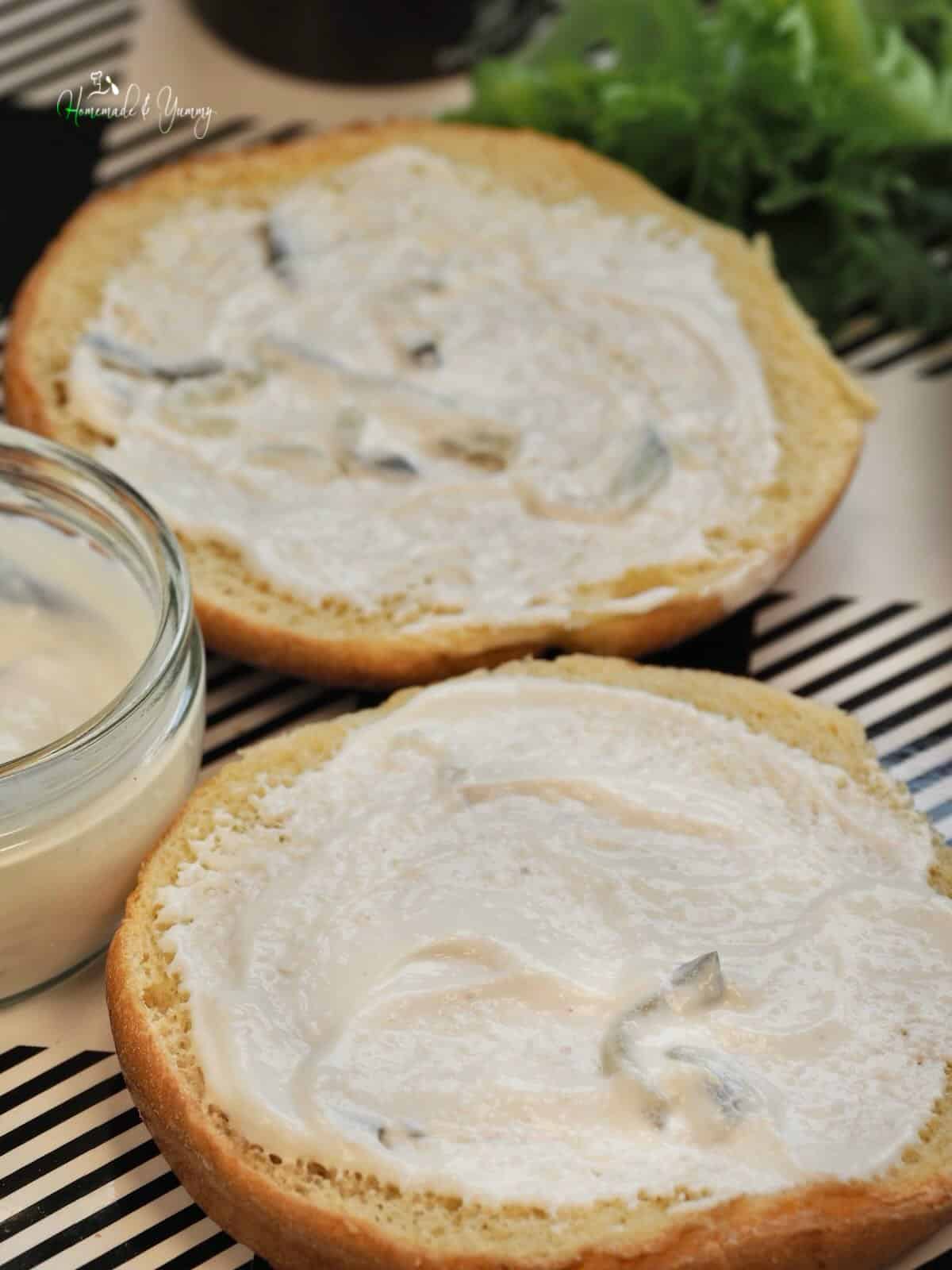 Mayo spread on a sandwich bun.