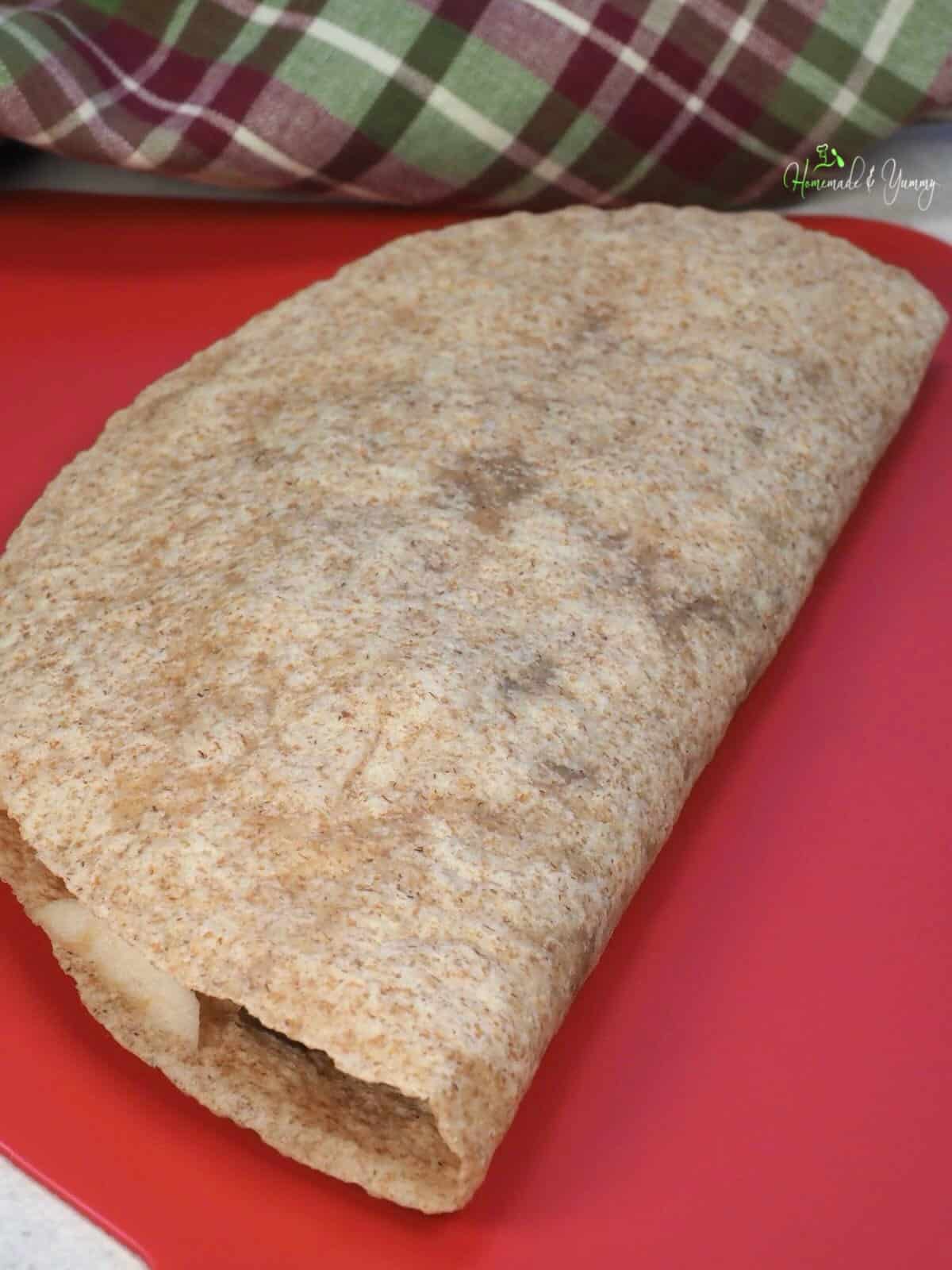 A quesadilla folded in half before grilling.