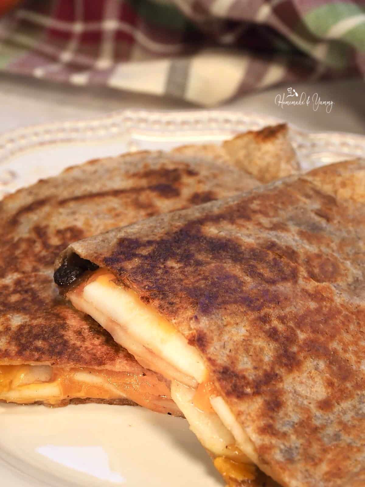 Grilled quesadilla with apples, cheese and onion jam.